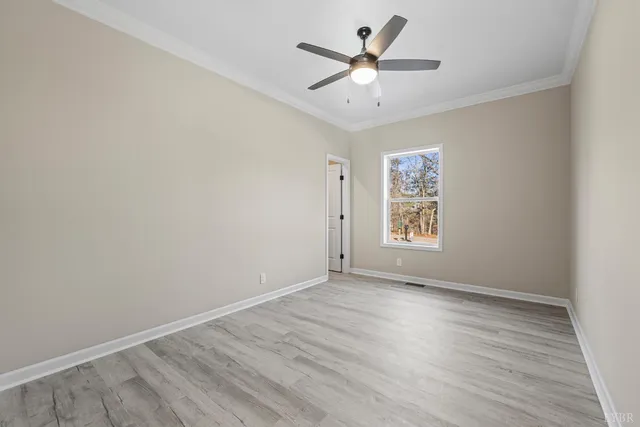 a view of backyard with seating space and trees in the background