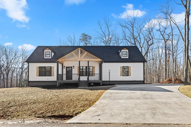 a view of a house with a wooden fence