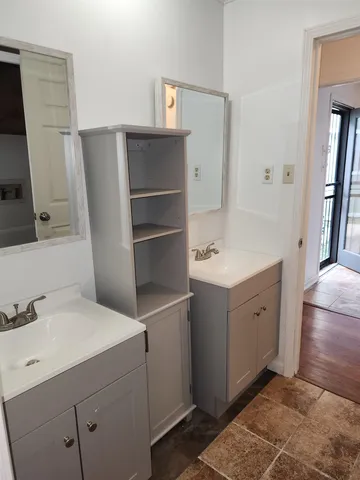 a bathroom with a double vanity sink and mirror