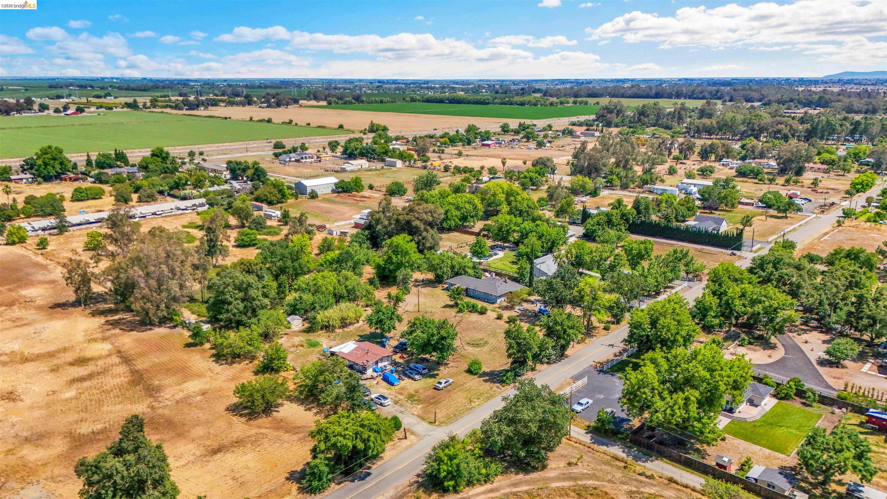 7750 Locke Road Vacaville, CA 95688 - Photo 11 of 23 Expansive aerial perspective showcasing a rural landscape with scattered residential properties