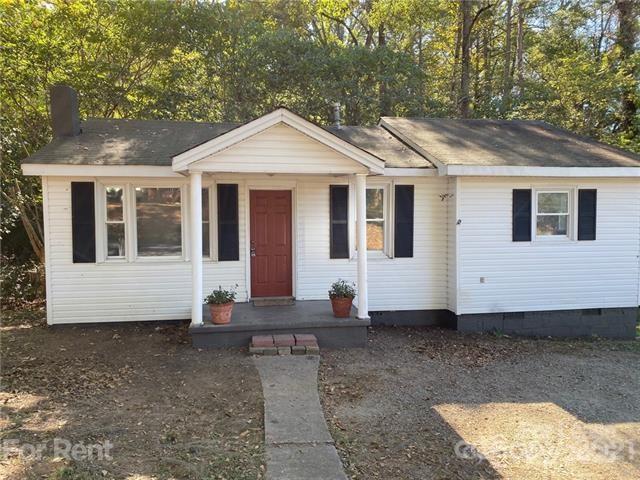 517 West Henry Street Belmont, NC 28012 - Photo 2 of 7 a view of a white house with a yard