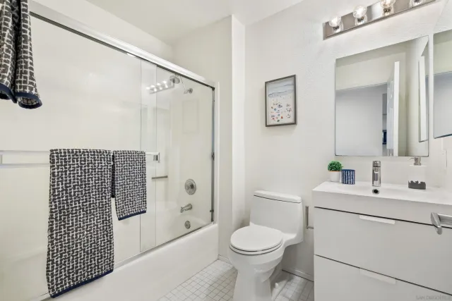 a bathroom with a toilet sink and shower