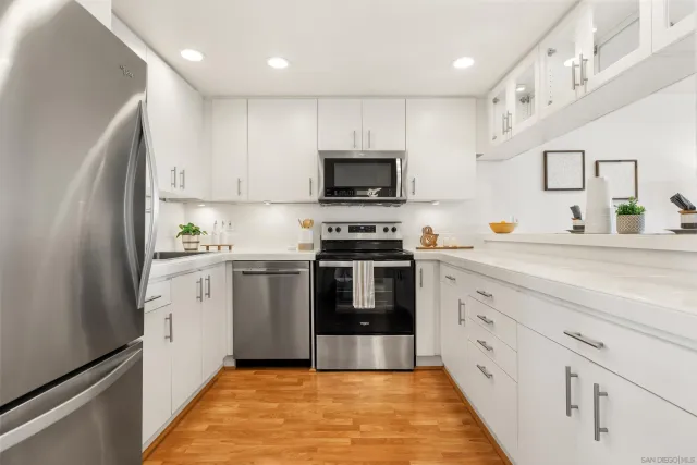a kitchen with granite countertop a sink and steel appliances