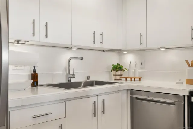 a kitchen with white cabinets and a sink