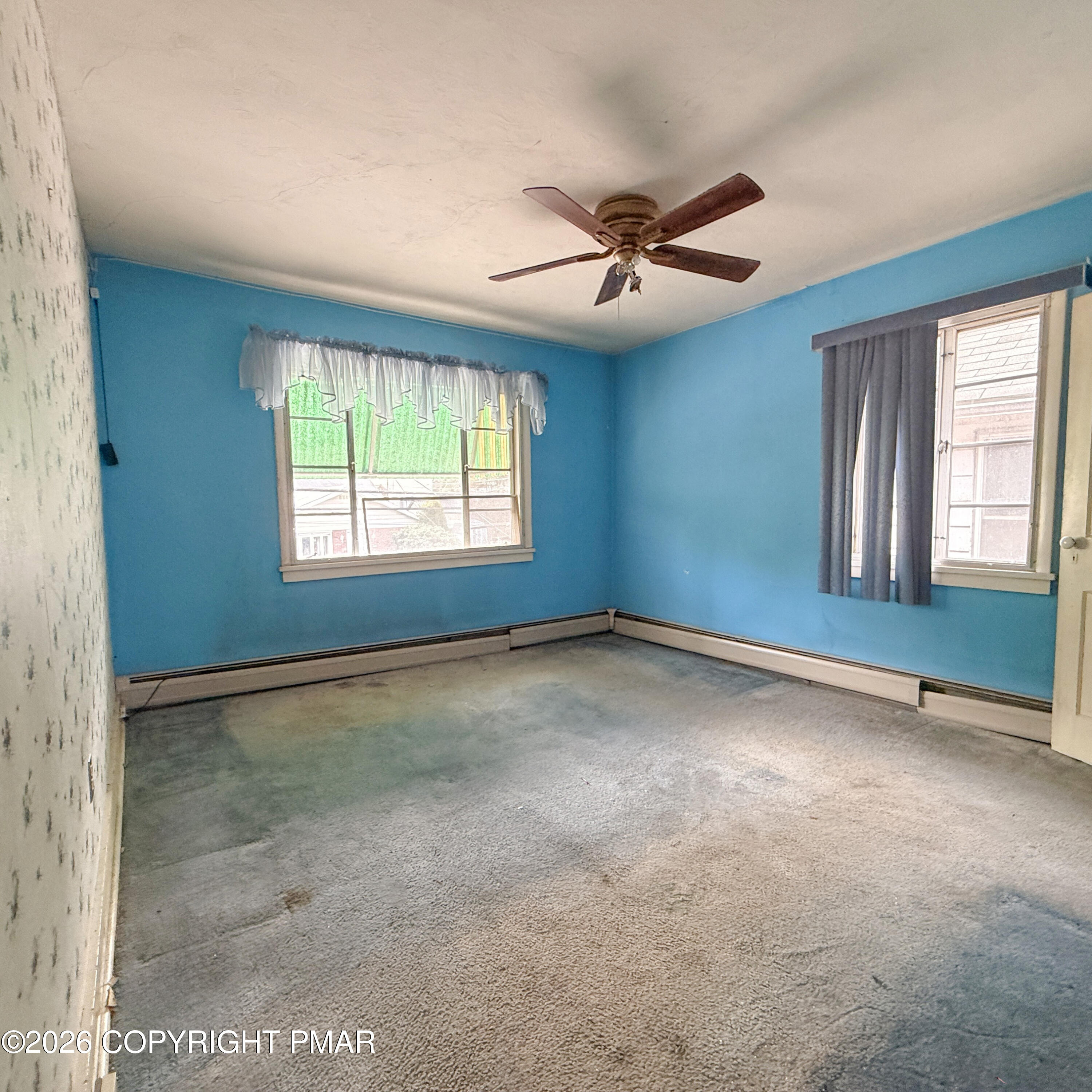 180 Parsonage Street Pittston, PA 18640 - Photo 14 of 19 an empty room with windows and fan