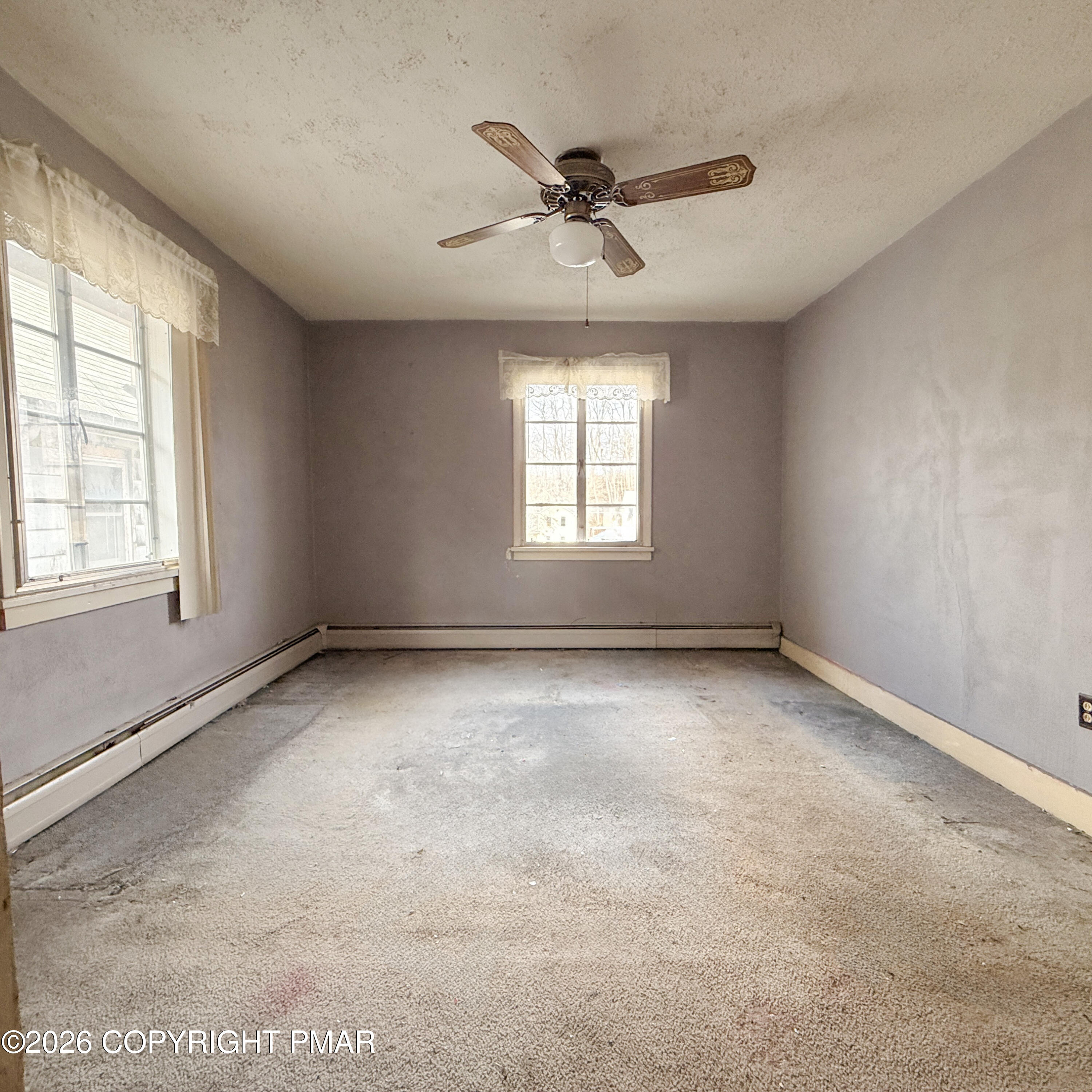 180 Parsonage Street Pittston, PA 18640 - Photo 17 of 19 an empty room with a window and a ceiling fan