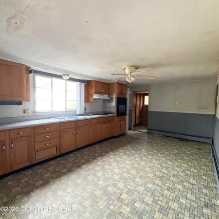 a view of a kitchen with closet and window