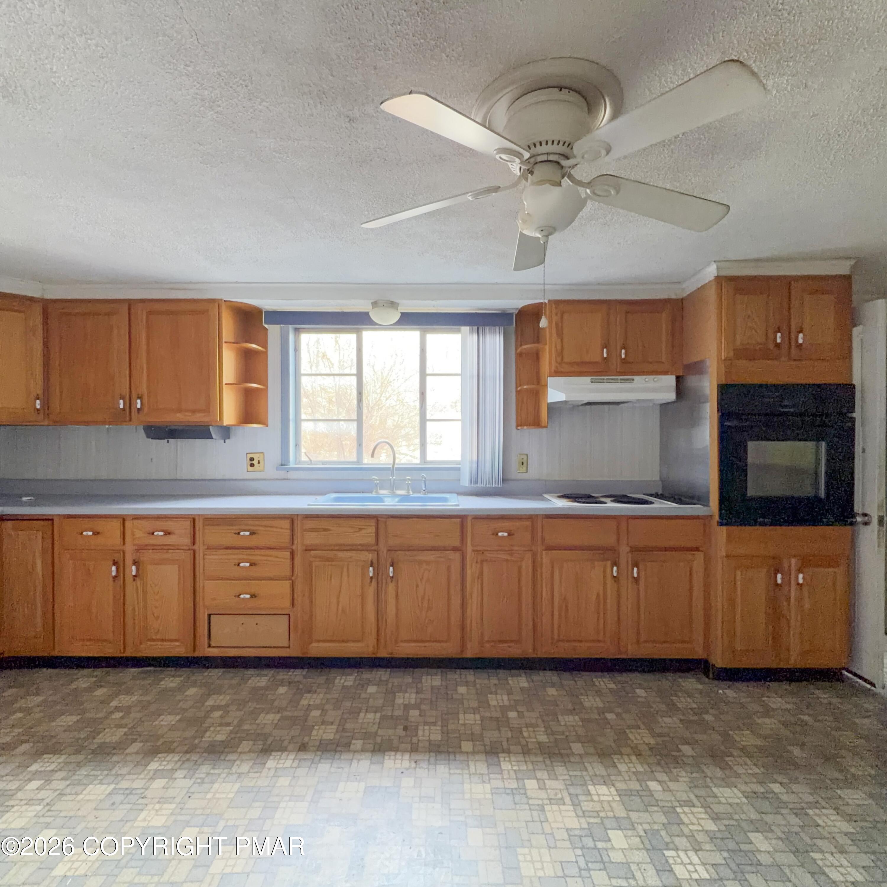 180 Parsonage Street Pittston, PA 18640 - Photo 10 of 19 a large kitchen with granite countertop a stove a sink and a refrigerator