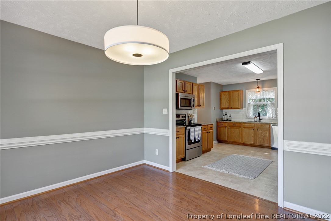 5823 Spreading Branch Road Hope Mills, NC 28348 - Photo 12 of 49 a view of kitchen with window and wooden floor