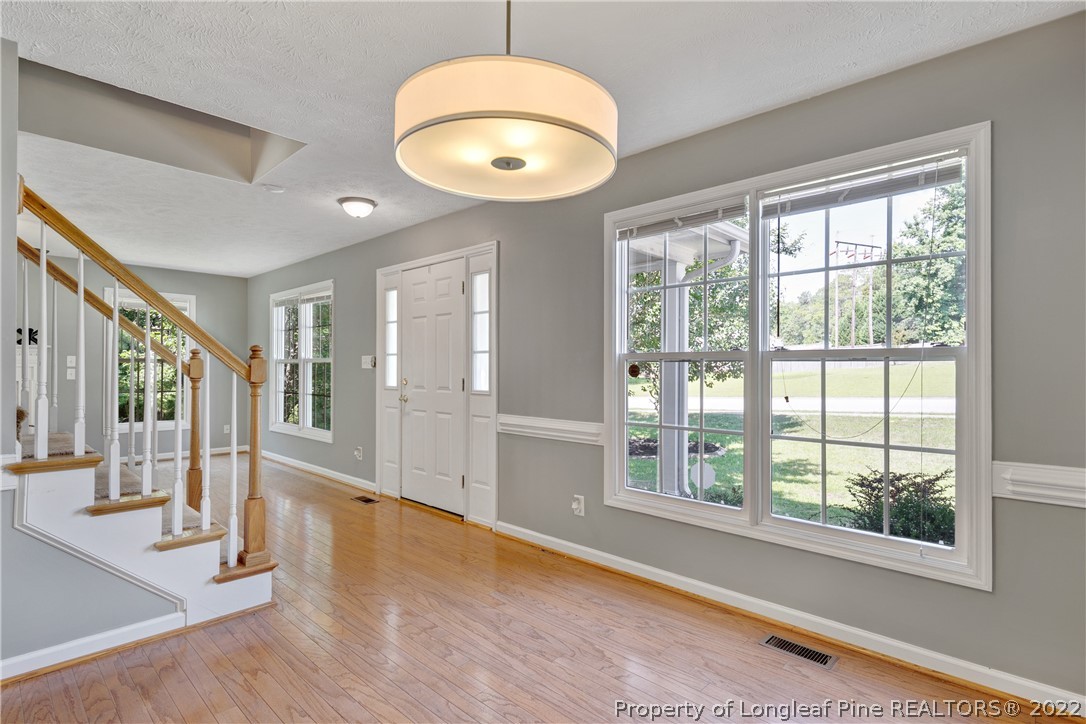 5823 Spreading Branch Road Hope Mills, NC 28348 - Photo 14 of 49 a view of an empty room with wooden floor and a window