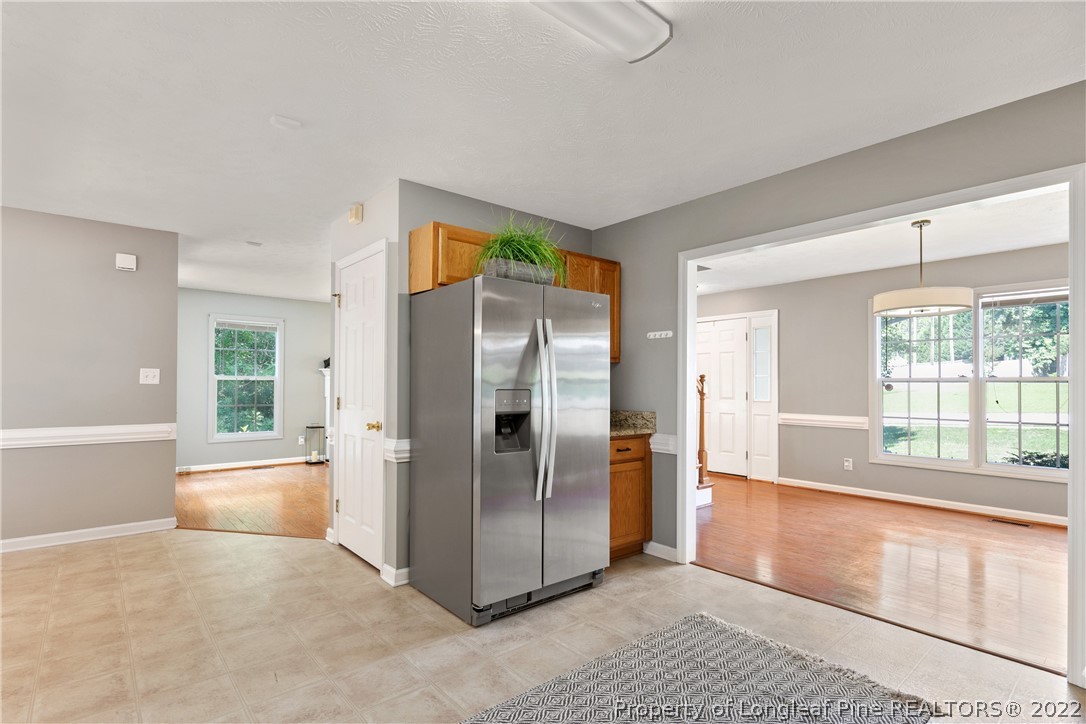 5823 Spreading Branch Road Hope Mills, NC 28348 - Photo 19 of 49 an empty room with large windows and refrigerator
