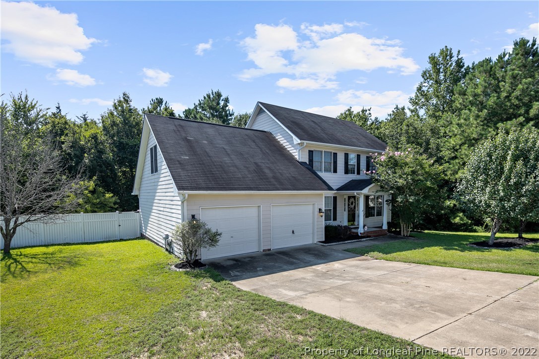 5823 Spreading Branch Road Hope Mills, NC 28348 - Photo 2 of 49 a view of a house with a garden and yard