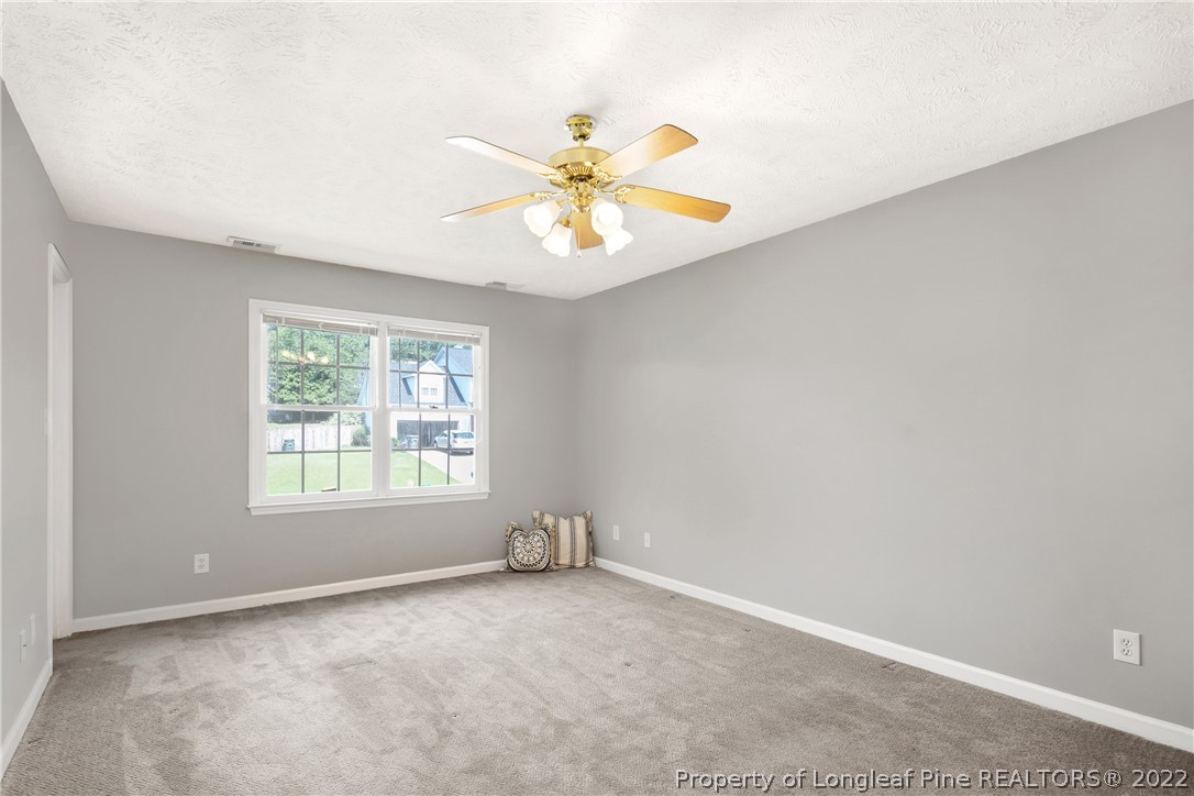 5823 Spreading Branch Road Hope Mills, NC 28348 - Photo 24 of 49 an empty room with windows and fan