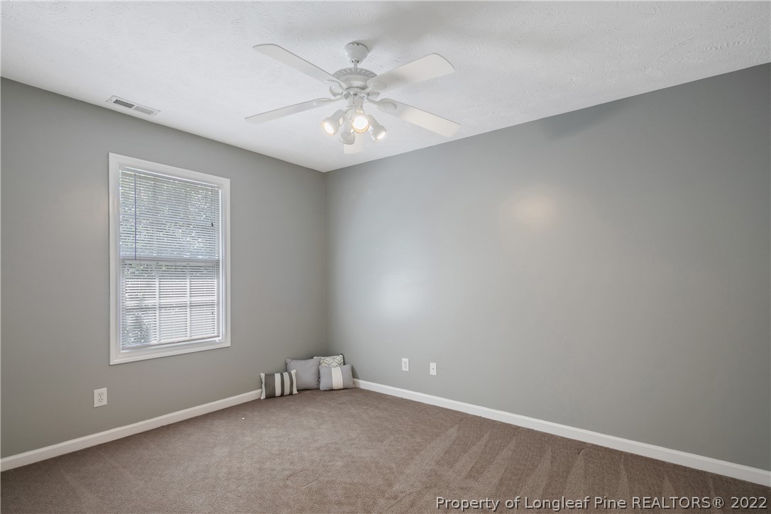 5823 Spreading Branch Road Hope Mills, NC 28348 - Photo 31 of 49 an empty room with windows and fan