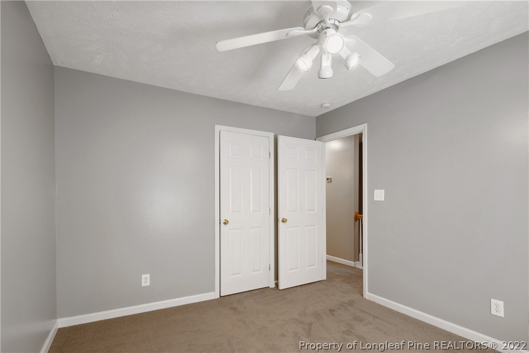 5823 Spreading Branch Road Hope Mills, NC 28348 - Photo 33 of 49 an empty room with chandelier fan and closet area