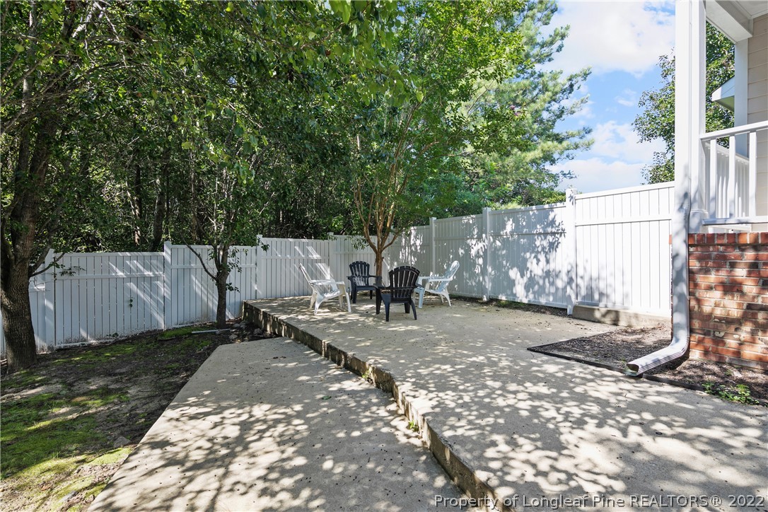 5823 Spreading Branch Road Hope Mills, NC 28348 - Photo 47 of 49 a view of a patio with table and chairs with wooden fence and plants