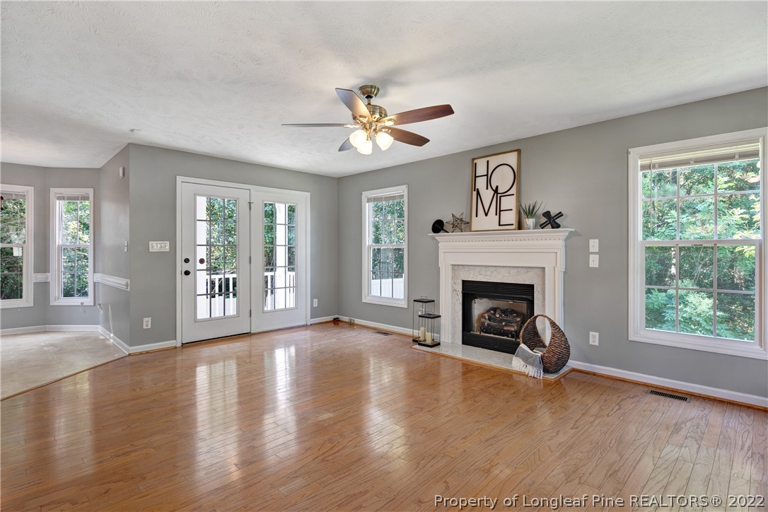 5823 Spreading Branch Road Hope Mills, NC 28348 - Photo 7 of 49 a view of a livingroom with a fireplace a ceiling fan and a fireplace