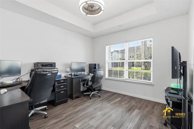 a living room with furniture and a view of kitchen