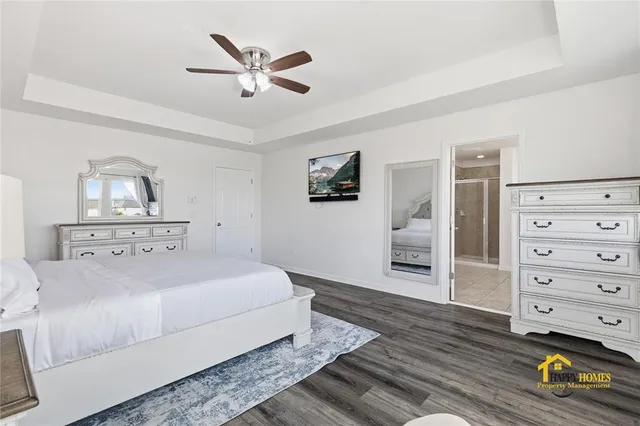 a spacious bathroom with a tub sink and mirror