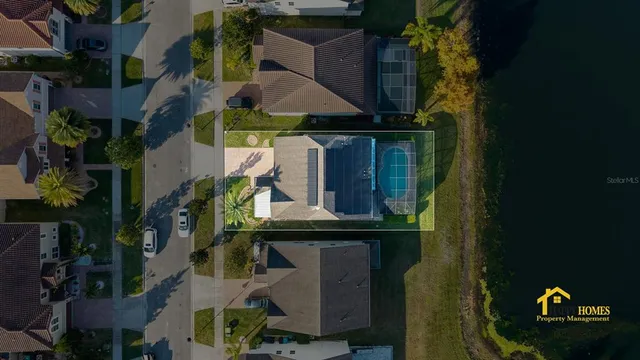 a kitchen with stainless steel appliances granite countertop a refrigerator a stove a sink a dining table and chairs