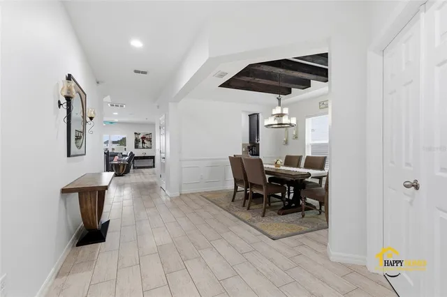 a view of a dining room with furniture and chandelier