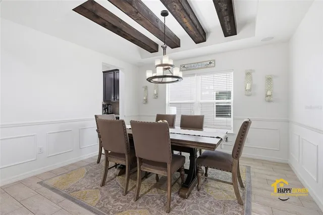 a view of a dining room with furniture and chandelier