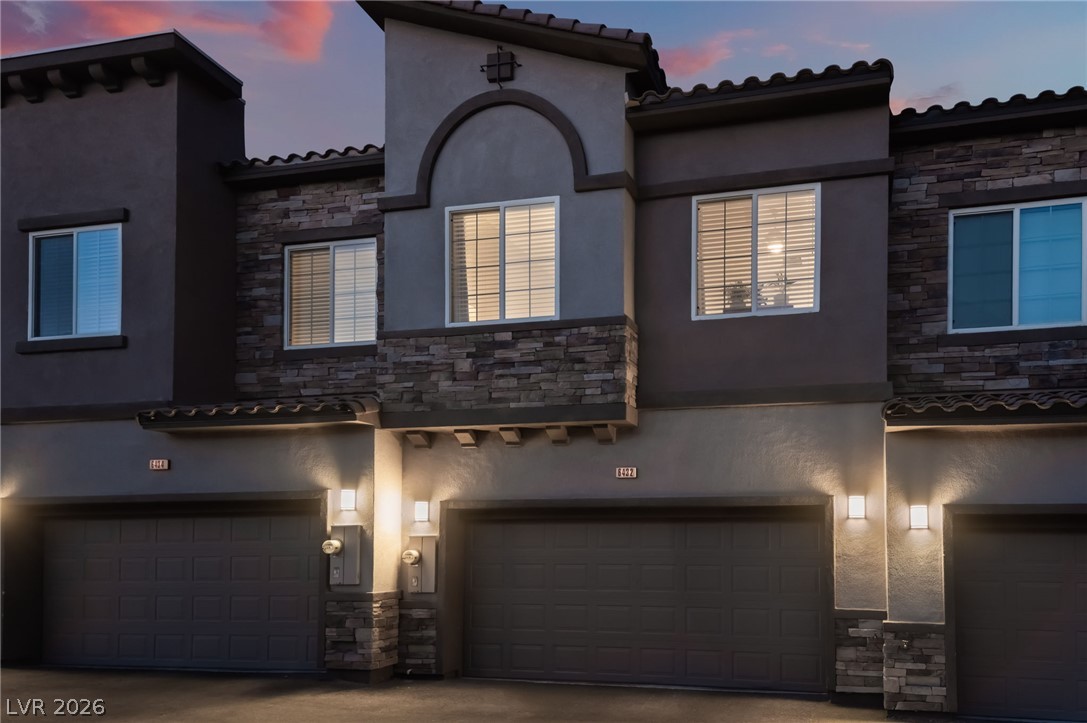6432 Spring Jog Street Las Vegas, NV 89166 - Photo 53 of 61 A striking facade with varied textures and thoughtful lighting creates inviting curb appeal.