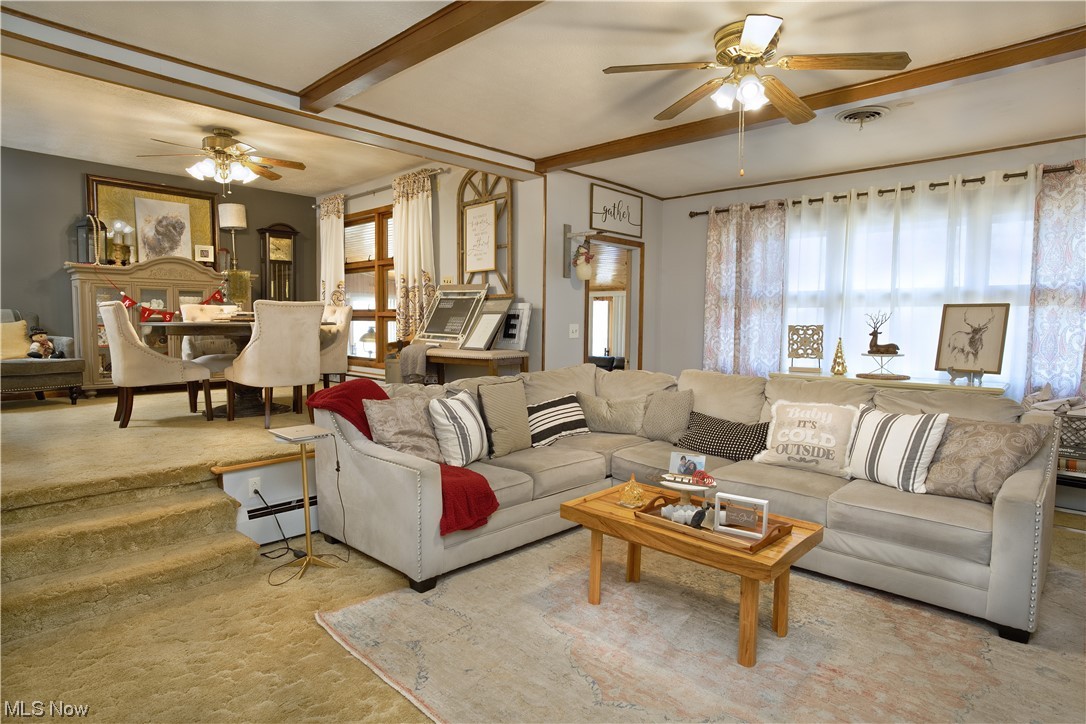 4061 Marks Rootstown, OH 44272 - Photo 8 of 25 Living room featuring beamed ceiling, a baseboard radiator, ceiling fan, and light carpet