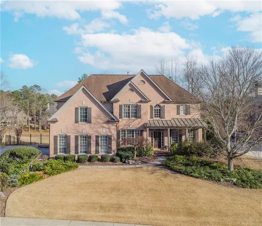 a front view of a house with yard and green space