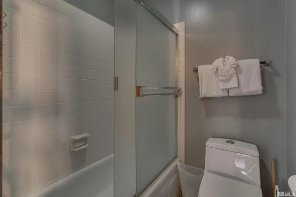 a bathroom with a toilet and tub