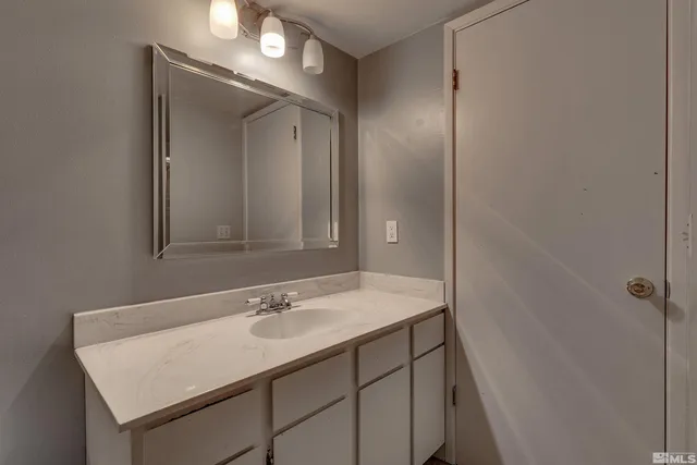 a bathroom with a sink vanity and a mirror
