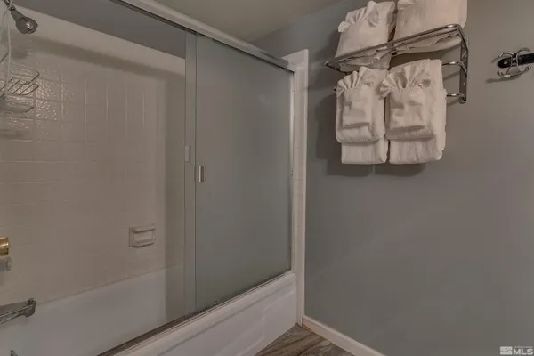 a bathroom with a glass shower door