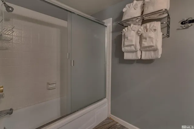 a bathroom with a glass shower door