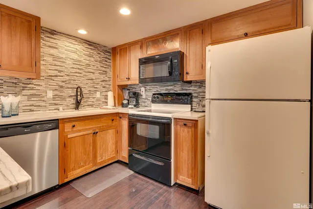 a kitchen with stainless steel appliances a refrigerator stove and microwave