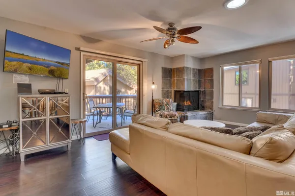 a living room with furniture and a flat screen tv with wooden floor