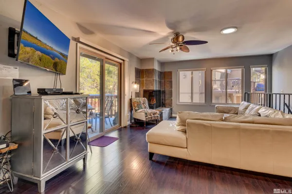 a living room with furniture a fireplace and a flat screen tv