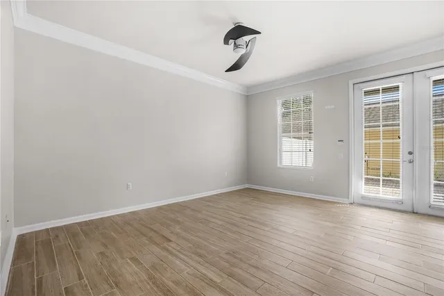 wooden floor in an empty room with a window