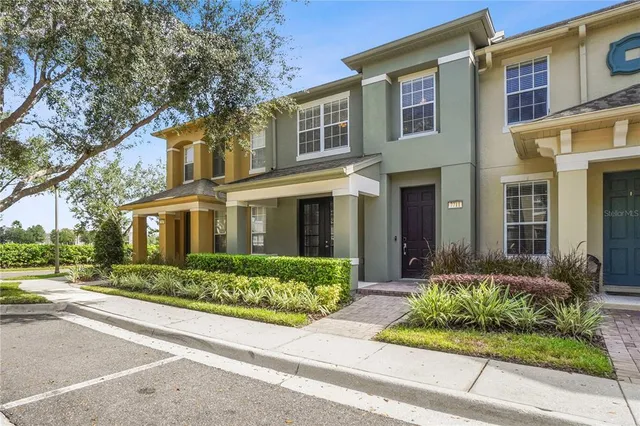 front view of a brick house with a yard