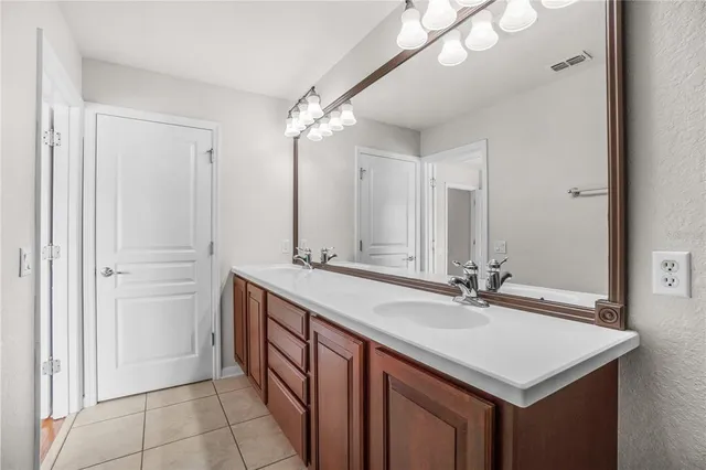 a bathroom with a sink double vanity and a mirror