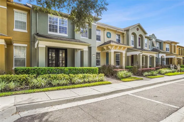 front view of a brick house with a yard