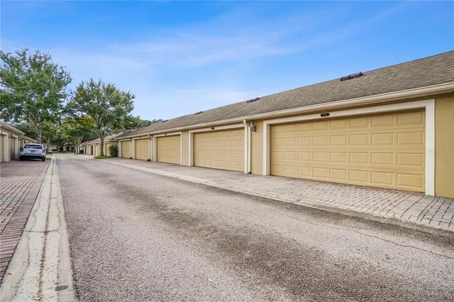 a view of garage and wooden fence