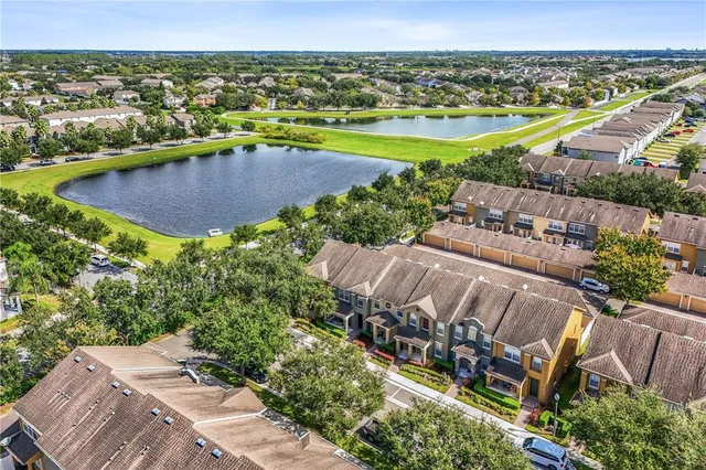 an aerial view of a house with a garden and lake view