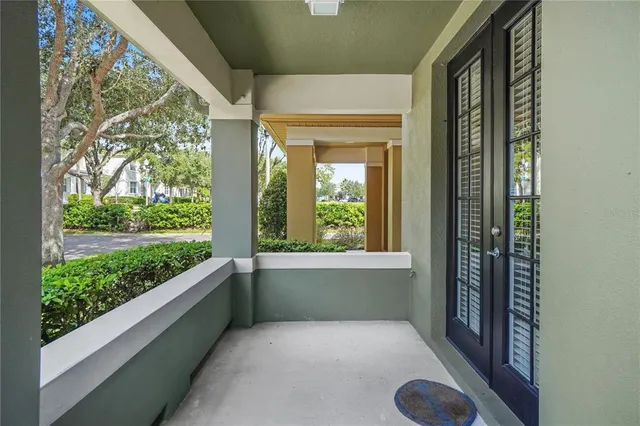 a view of an empty room with a window and front door