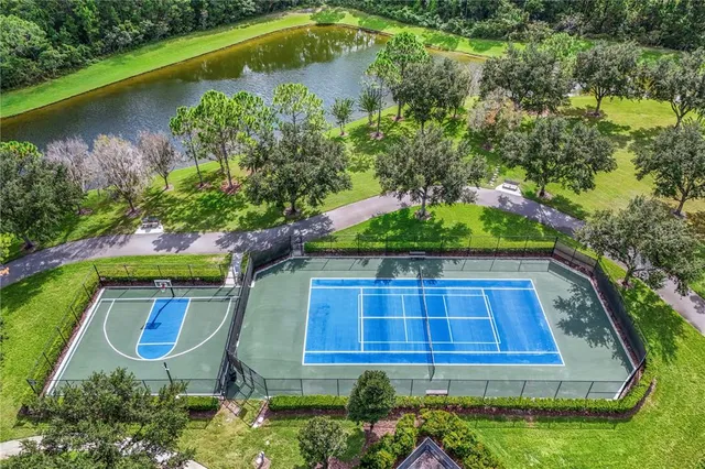 an aerial view of a house with swimming pool and lake view