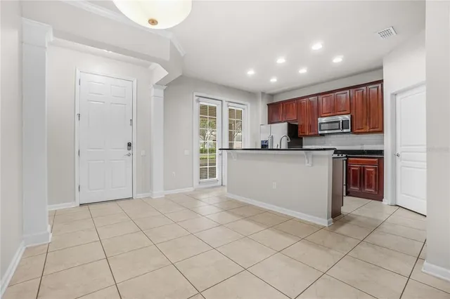 a kitchen with stainless steel appliances granite countertop a refrigerator sink and cabinets