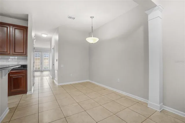 a view of a kitchen with a dishwasher cabinets and a floor to ceiling window