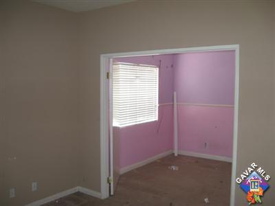 11544 Spring Street Adelanto, CA 92301 - Photo 11 of 15 an empty room with a window