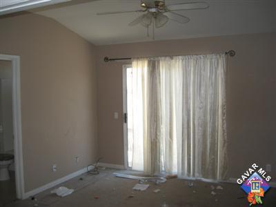 11544 Spring Street Adelanto, CA 92301 - Photo 12 of 15 an empty room with a window