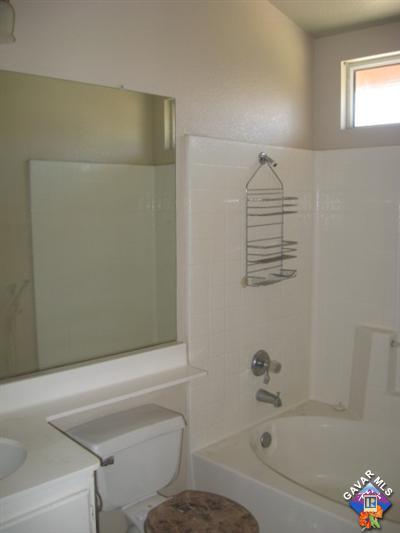 11544 Spring Street Adelanto, CA 92301 - Photo 13 of 15 a bathroom with a bathtub and shower