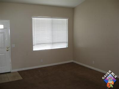 11544 Spring Street Adelanto, CA 92301 - Photo 2 of 15 an empty room with a window